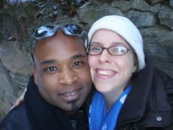 An overjoyed woman presses her cheek to a handsome man's while they both smile