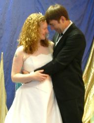 A couple dance and lean close together on their wedding day
