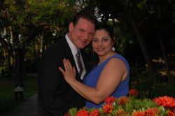 New Jersey Christian singles smile and hug outdoors next beautiful flowers