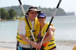 A Christian couple pose while rafting at the beach