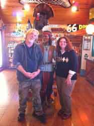 A happy couple pose inside a general store