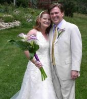 Christian friend smiles with her soulmate at their outdoor wedding
