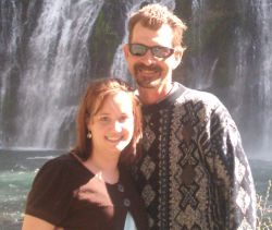 Cut Christian singles smile and pose together in front of a waterfall