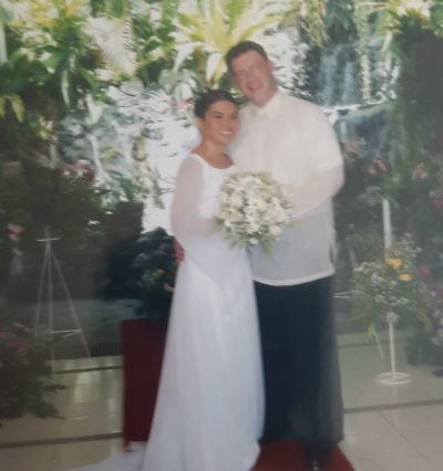 Alaskan man stands proudly next to his Asian wife in the Philippines