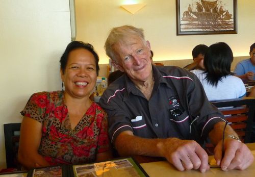 A Filipina Christian single is seated next to a New Zealand Christian single man at a restaurant