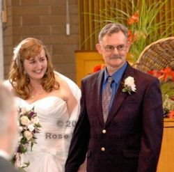 BC Christian singles marry and are full of smiles while walking down the aisle