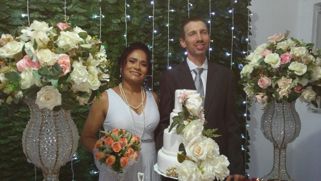 Married couple surrounded by flowers