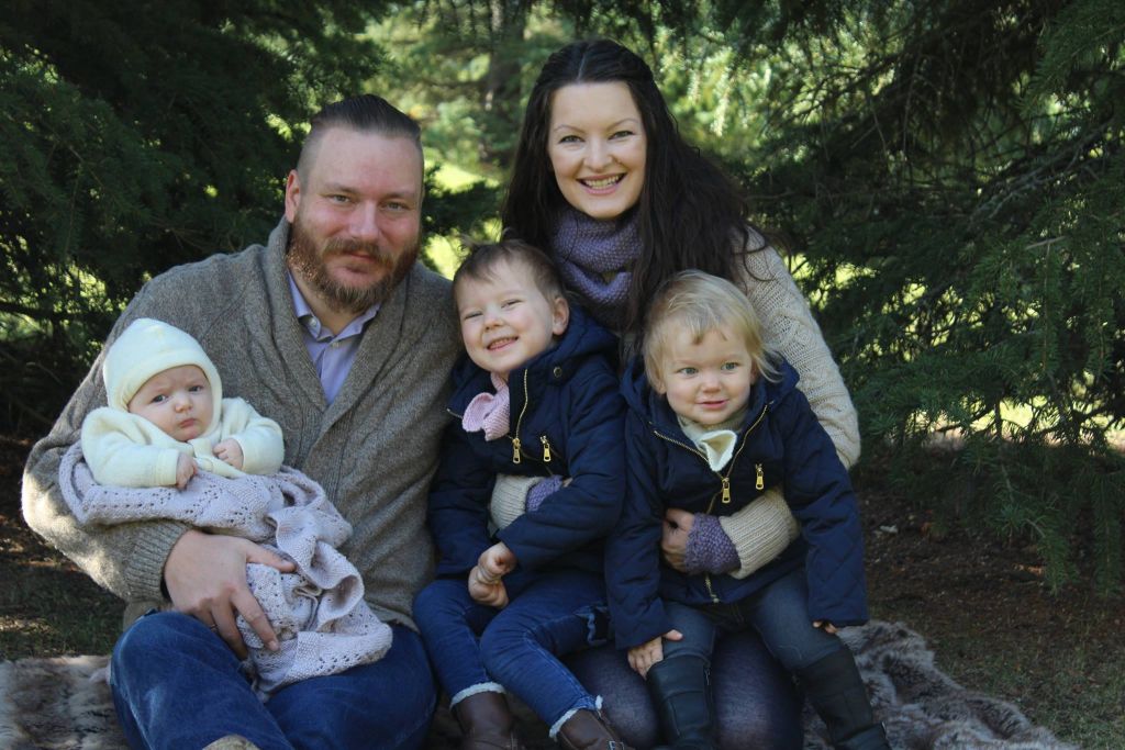 Christian couple married 9 years holding their 3 babies