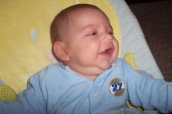 Cut baby in blue laughs