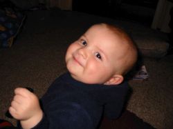 A baby looks very pleased!