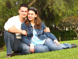 Cute couple cuddle on the grass