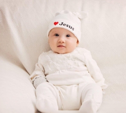 A cute baby wears a Jesus hat