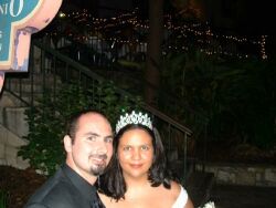 A Christian bride wearing a wedding tiara smiles next to her new husband at their wedding