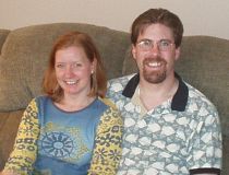 Romantic Christian man sits on the couch after winning over a pretty woman