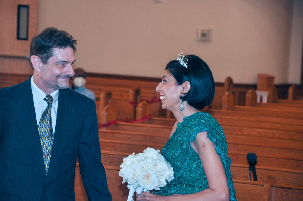 A beautiful mature Asian Christian woman smiles at her White husband