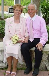Christian runner sits hand in hand with his new wife, who smiles ear to ear
