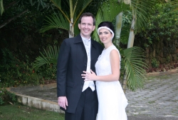 A very peaceful and relaxed young couple stand very close to each other outside 