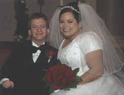Online dating brought this happy Christian couple together. Shown smiling on their wedding day