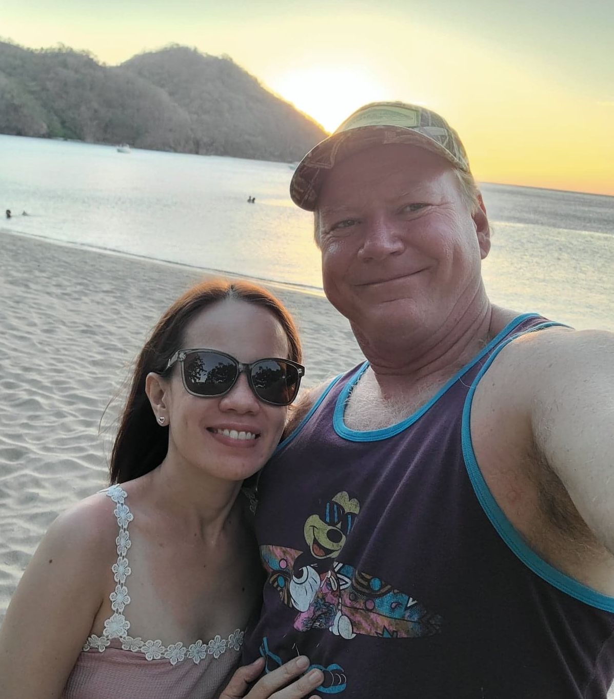 Very happy Christian couple takes selfie with beautiful sunset in background