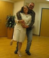 A couple dance for joy while hugging