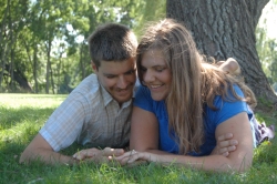 Romantic Christian singles from New England lie on the grass and admire her ring