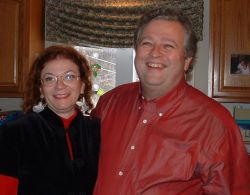 Cathi and Chuck at Christmas party laughing together