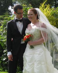 A man stares lovingly at his beautiful red-headed wife on her wedding day