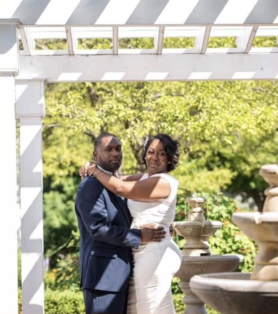 Newly married Christian couple hugging in garden