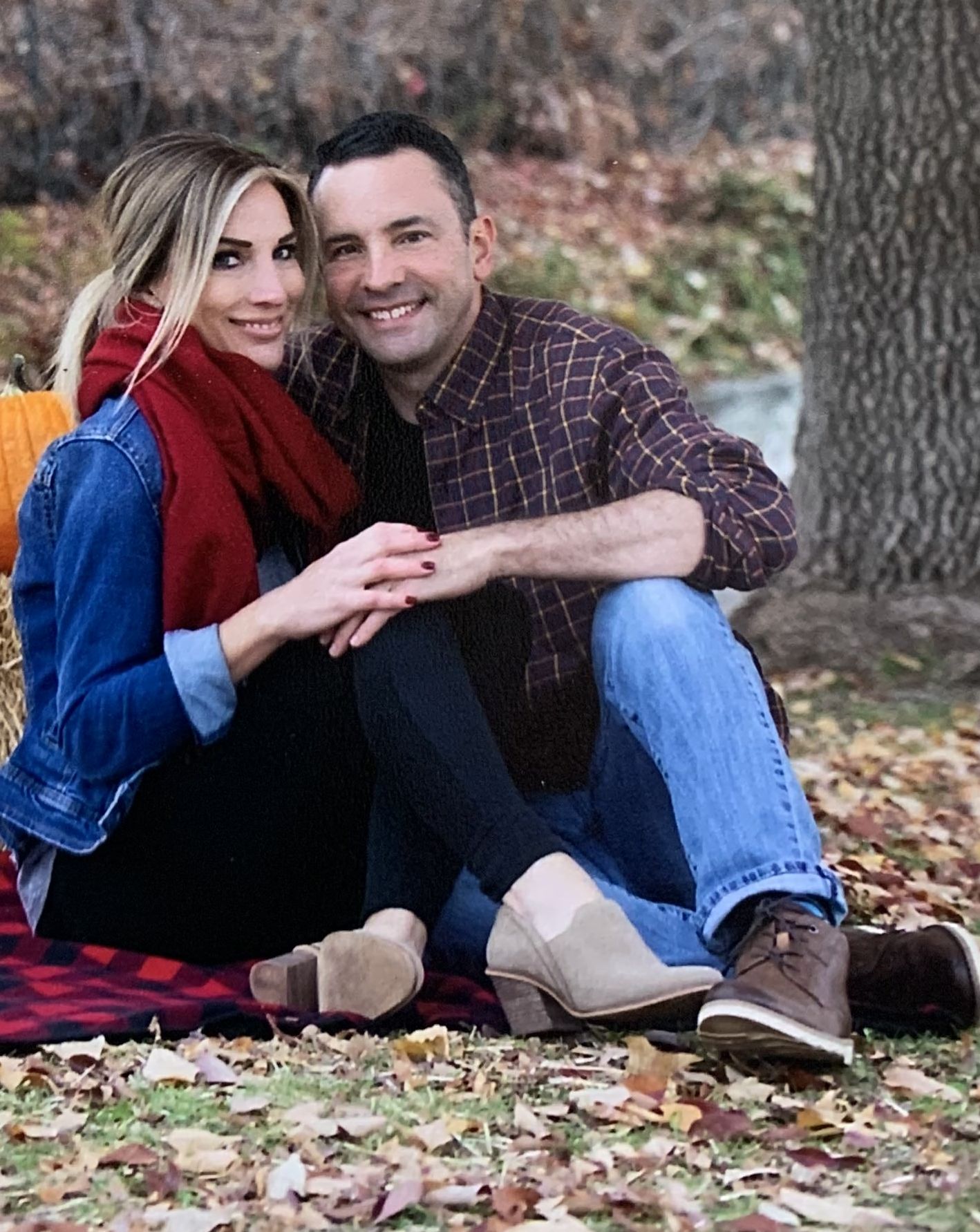 Christian singles hold hands while seated in the forest