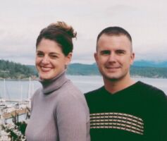 Cute Christian couple smile together in harbour