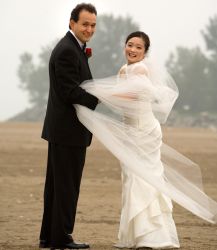 Man catches his wife's dress on a very windy wedding day