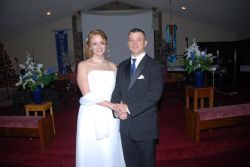A relaxed and thankful Christian couple pose together in a church after marrying