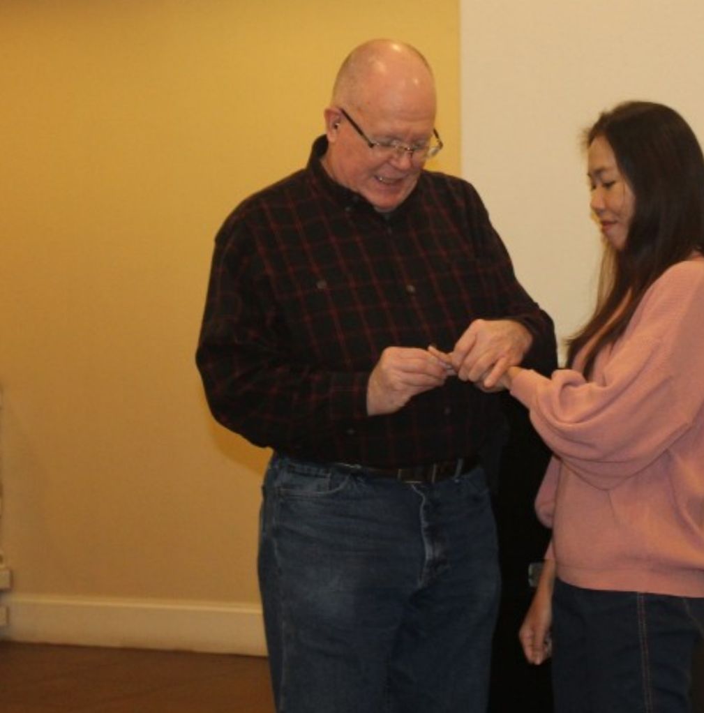 A Christian man puts a wedding ring on his new bride's finger