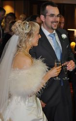 Christian wedding reception with groom in big smiles