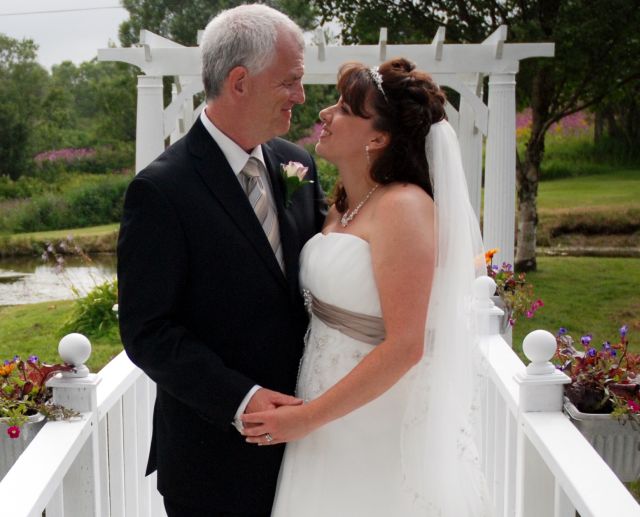 Newlyweds from NB stare into each other's eyes and smile at their outdoor wedding