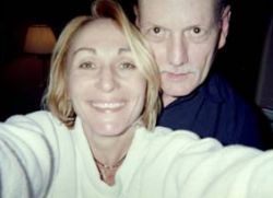 A man lets a pretty woman take a selfie of the two of them