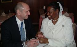 A woman smiles bashfully as a British Christian man smiles at her lovingly