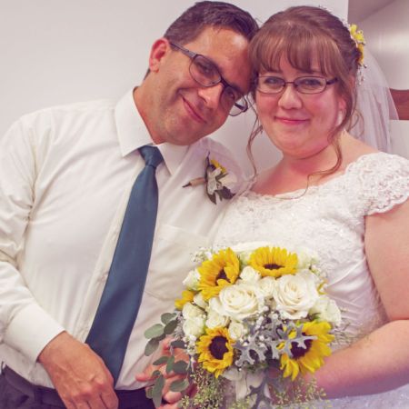 Patient Christian single marries his dear bride who holds beautiful bouquet