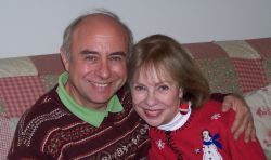 Senior Christians cuddle on the couch and smile in the wintertime