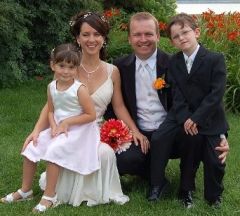 New life for blended Christian family who pose at outdoor wedding