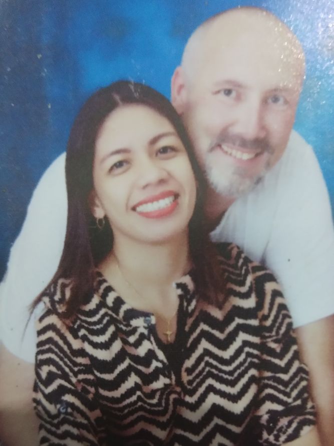 Interracial couple engaged and full of joy as they hold each other and smile