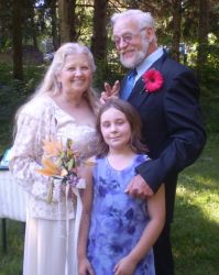 Widowed grandmother marries and stands next to her husband and granddaughter