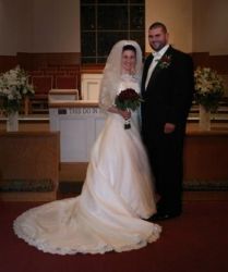 Smiling couple stand together in the church after marrying