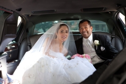 A beautiful couple from Connecticut sit together in a fancy car after marrying