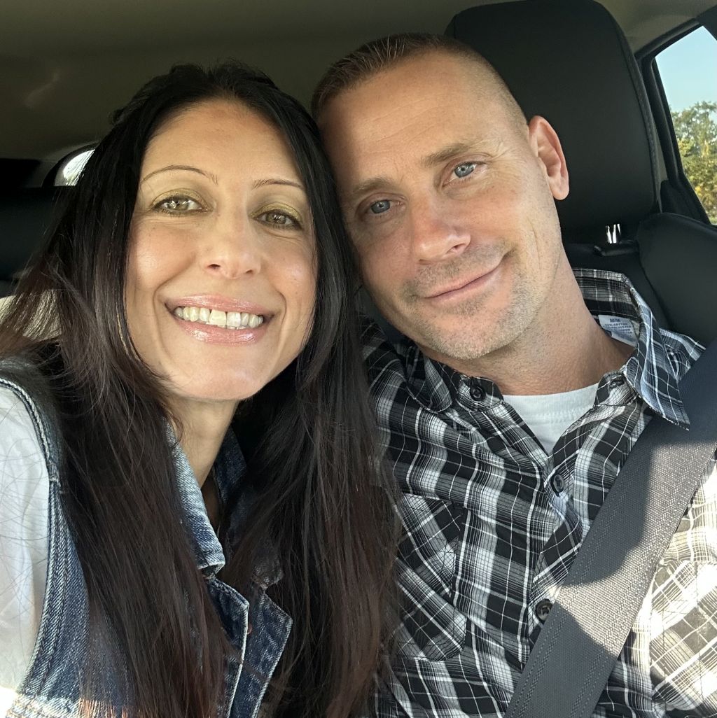 A Christian couple pose in the car while on a road trip date