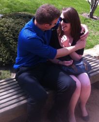 Illinois Christian singles hug while sitting on a bench, overjoyed at meeting each other