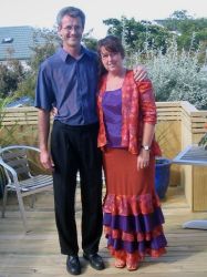 Former NZ Christian singles stand next to each other and embrace on a porch