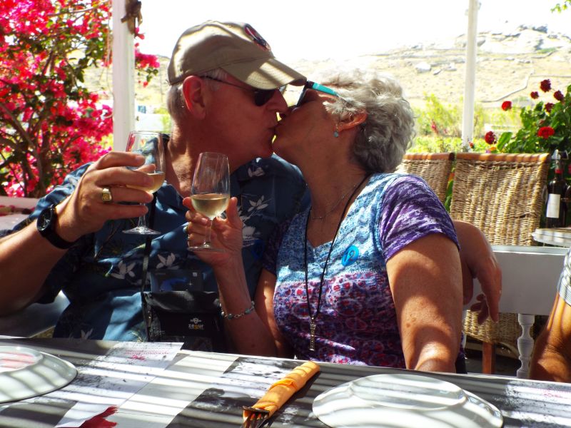 A Christian couple kiss at dinner as part of a toast
