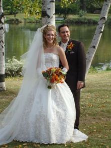 A very happy couple of former single Christians from Illinois pose together by a river after marrying
