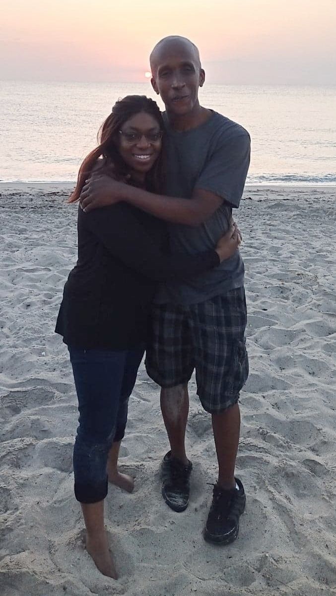 Former Black single Christians hug at sunset at the beach